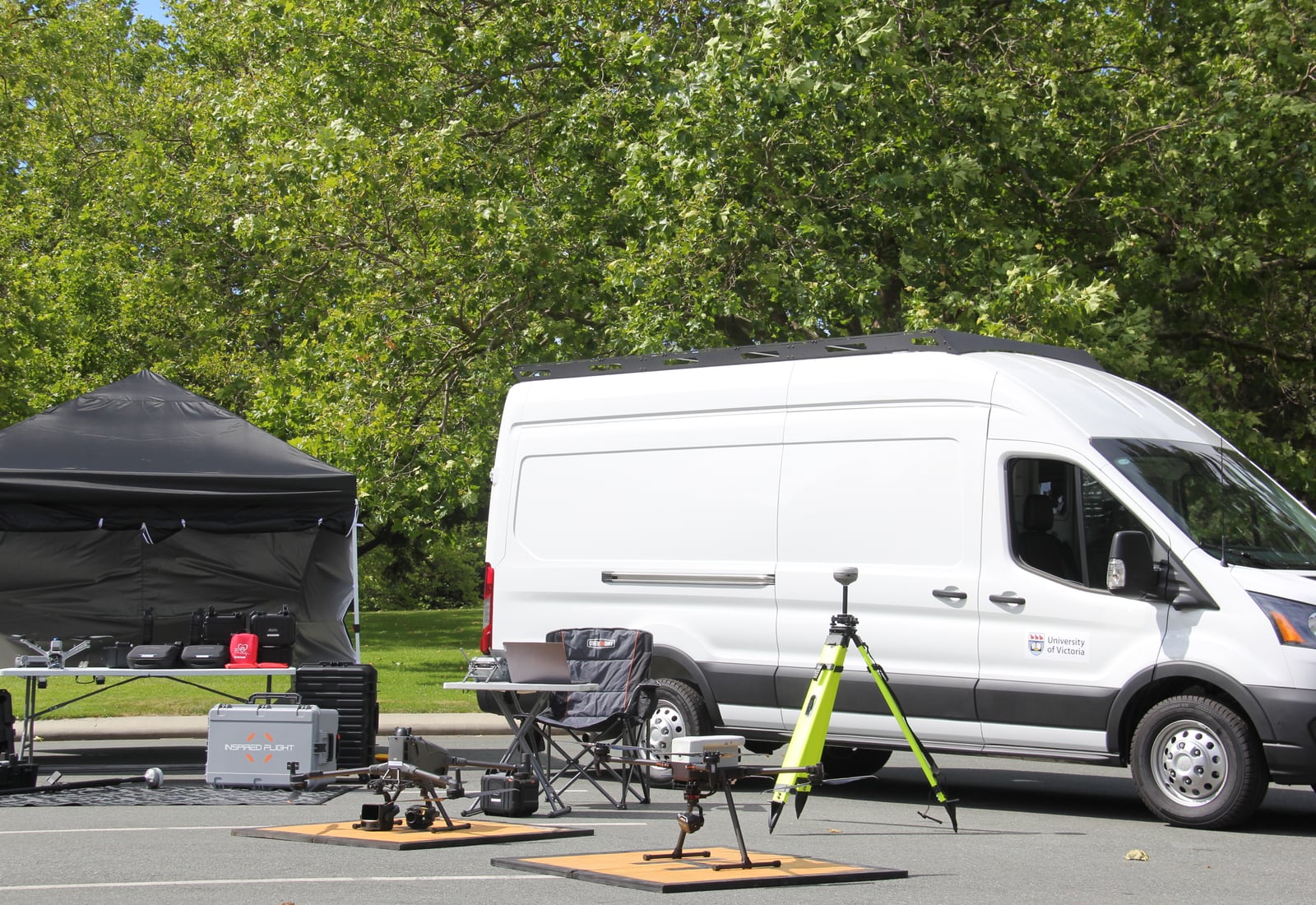 ACIS drone and surveying equipment staged beside a University of Victoria field vehicle.