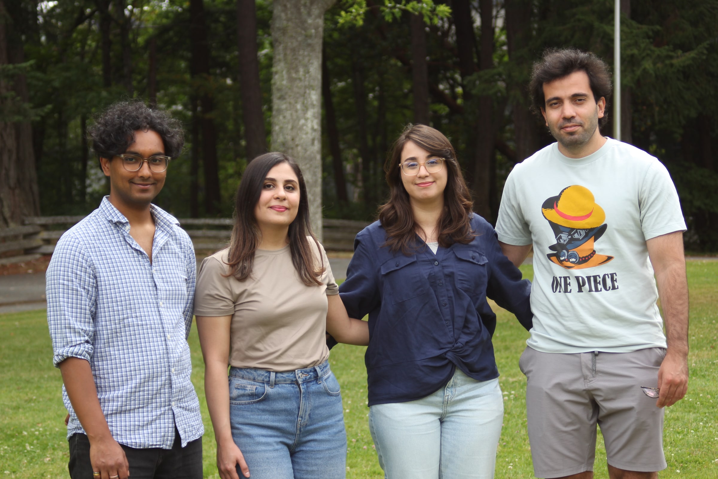 Four ACIS team members standing together outdoors.